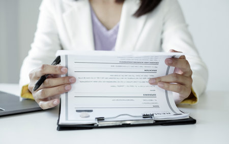 Business woman employer holding resume hiring recruit looking cv resume to hire candidates, analyzing information before job interview. Recruitment concepts.の写真素材