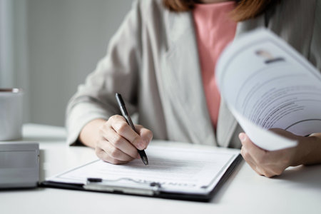 Business woman employer holding resume hiring recruit looking cv resume to hire candidates, analyzing information before job interview. Recruitment concepts.の写真素材