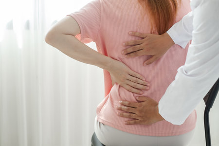 Female physiotherapists provide physical assistance to women patients with back injuries back massages for relaxation and muscle recovery in the rehabilitation center.の写真素材