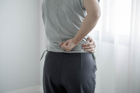 Woman having back pain pain during work long time. stretching to relax and relax while working hard at the office.の写真素材