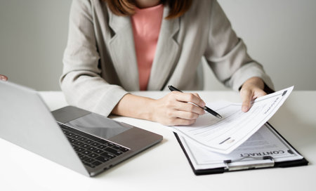 Business woman employer holding resume hiring recruit looking cv resume to hire candidates, analyzing information before job interview. Recruitment concepts.の写真素材