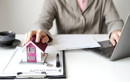 Agents working in real estate investment and home insurance signing contracts in accordance with the home buying insurance agreements approving purchases for clients. concept Home insurance.の写真素材