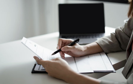 Business woman employer holding resume hiring recruit looking cv resume to hire candidates, analyzing information before job interview. Recruitment concepts.の写真素材