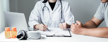 Female doctors who treat patients make an appointment to listen to the results after a physical examination and explain medical information and diagnose the disease. Medical concepts and good health.の写真素材