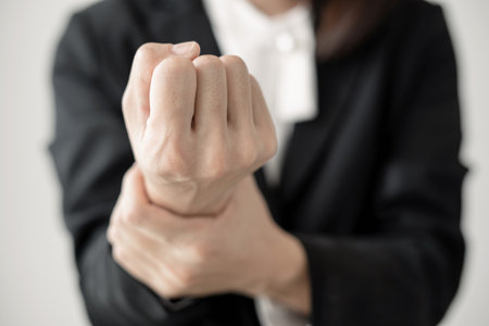 Woman hand with wrist pain numbness and pain in the palm of the hand has pain and tingling in the nerve endings This is a side effect of sitting and working for a long time on a laptop at the office.の写真素材