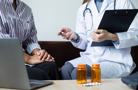 Female doctors who treat patients make an appointment to listen to the results after a physical examination and explain medical information and diagnose the disease. Medical concepts and good health.の写真素材