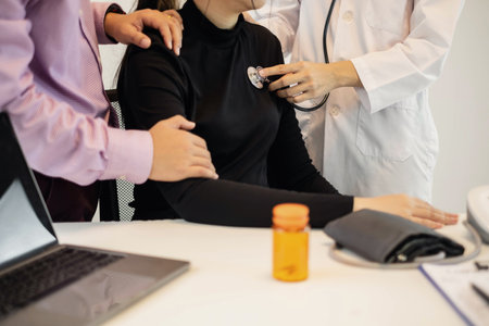 The female doctor measured blood pressure, the patient examined the heartbeat and sat down to talk about health care closely. health care concept.の写真素材