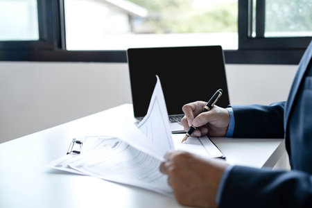 Business man employer holding resume hiring recruit looking cv resume to hire candidates, analyzing information before job interview. Recruitment concepts.の写真素材