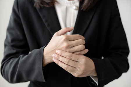 Woman hand with wrist pain numbness and pain in the palm of the hand has pain and tingling in the nerve endings This is a side effect of sitting and working for a long time on a laptop at the office.の写真素材