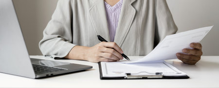 Business woman employer holding resume hiring recruit looking cv resume to hire candidates, analyzing information before job interview. Recruitment concepts.の写真素材