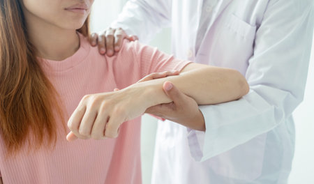 Female physiotherapists provide physical assistance to women patients with elbow injuries examine patients in rehabilitation centers. Physiotherapy concepts.の写真素材