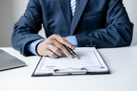 Business man employer holding resume hiring recruit looking cv resume to hire candidates, analyzing information before job interview. Recruitment concepts.の写真素材