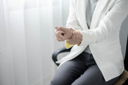 Woman hand with wrist pain numbness and pain in the palm of the hand has pain and tingling in the nerve endings This is a side effect of sitting and working for a long time on a laptop at the office.の写真素材