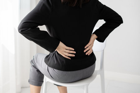 Woman having back body pain during work long time. stretching to relax and relax while working hard...