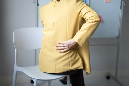 Woman having back body pain during work long time. stretching to relax and relax while working hard...