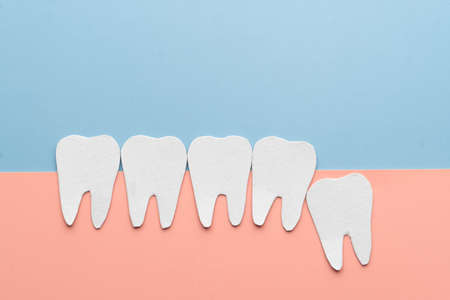 Impacted wisdom teeth with healthy tooth cartoon made from paper. Dental problems associated with wisdom teeth include tooth decay, jaw pain, oral infection or gum disease. Creative idea.の写真素材