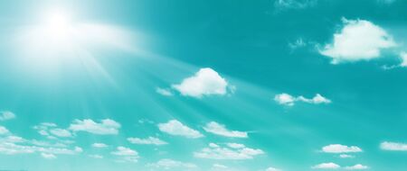 heaps in the blue sky with the sunの写真素材
