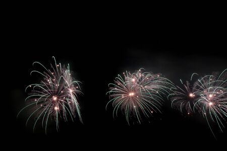 Colorful fireworks that explode and fill the darkness of the night sky with colored light.