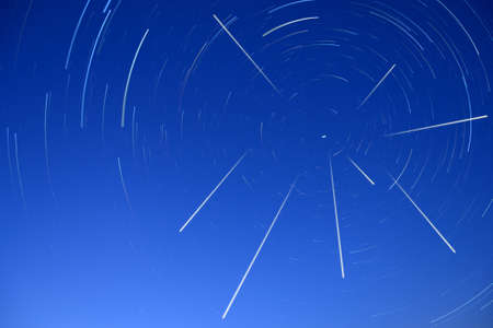 The Perseid meteor shower in the sky, Star trails around Polaris in the summer starry sky.の写真素材
