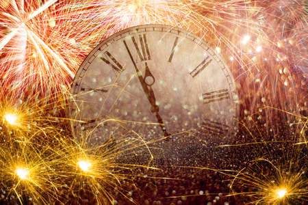 Fireworks New Year Clock.Countdown New Year's clock.Clock that marks a few minutes to the new year with torches and fireworks.の写真素材