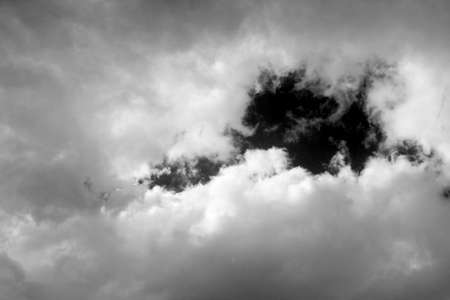 White clouds isolated on black sky background. Black sky and white clouds. Natural cumulus clouds,...
