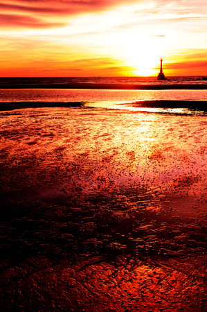 Colorful beach and lighthouse with sunset in Tarutao island, south of thailandの写真素材