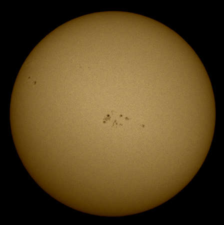 The sun and its black spots, in summer, through a telescope, solar filmの写真素材