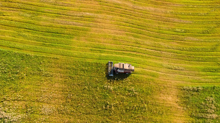 Agricultural work with a combine harvester from above, harvesting in September.