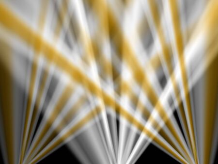 yellow and silver light beams against dark backgroundの写真素材