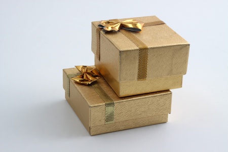 two goldem gift  ring boxes on top of each otherの写真素材
