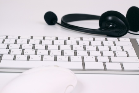 slim silver keyboard with mouse and headset on white backgroundの写真素材
