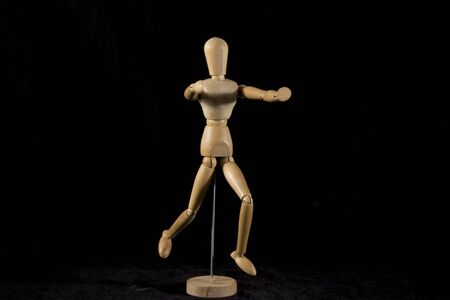 wood puppet running with open armsの写真素材