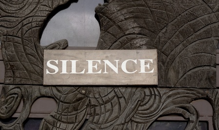silence sign on a door made of sculpured wood with glassの写真素材