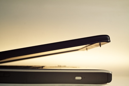 laptop closeup fading in the orange lit backgroundの写真素材