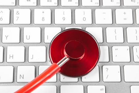 red tehthoscope on new silver keyboard closeupの写真素材