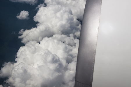 airplane engine closeup with white clouds in the backgroundの写真素材