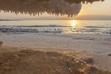 Salt Crystals formations all around on dead sea sunrise backgroundの写真素材