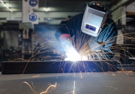 Welding with a lot of sparks in a metal industry factory の写真素材