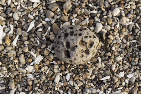 Meteorile on the seashore with small stones in the backgroundの写真素材
