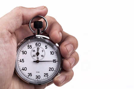 Retro analog stopwatch in a hand pointing on 15 seconds isolated on white backgroundの写真素材