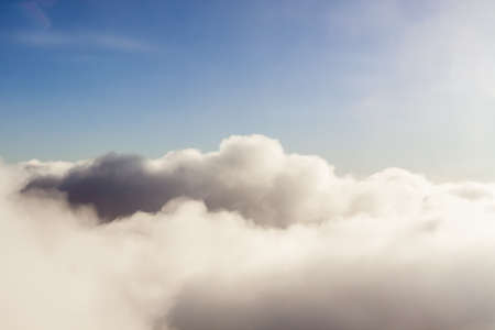 Fluffy morning clouds with blue sky flight view