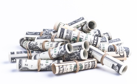 Pile of rolled dollars with elastic band isolaten on white background