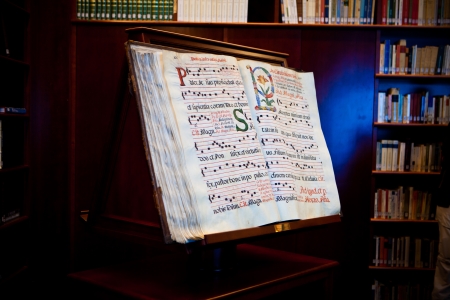 Old hand writen book ina library with books in the backgroundのeditorial素材