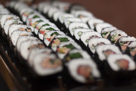 Tray full with colored shushi rows closeup selective focusの写真素材