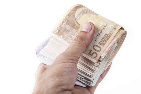 Man hand holding a bunch of euro banknotes isolated on white backgroundの写真素材