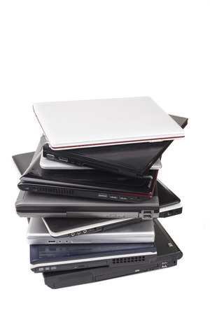 Pile of old laptops isolated on white の写真素材