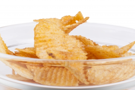Potato chips ina bowl closeup isolated on white backgroundの写真素材
