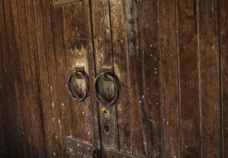 Old rusty  wooden double sided gate with round handles side viewの写真素材