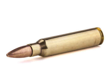 Single Bullet close-up isolated on white background with shadow under