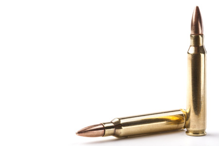 Two rifle bullets one vertical and the other orizontal isolated on white backgroundの写真素材